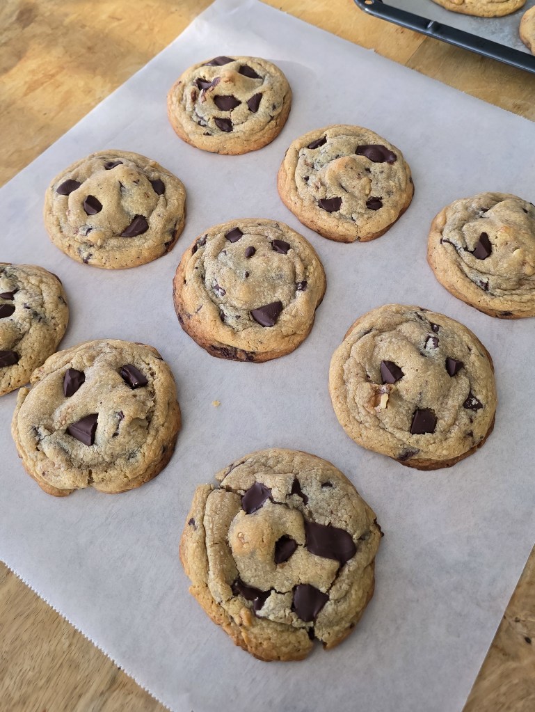 A tray of chocolate chip cookies out of the oven