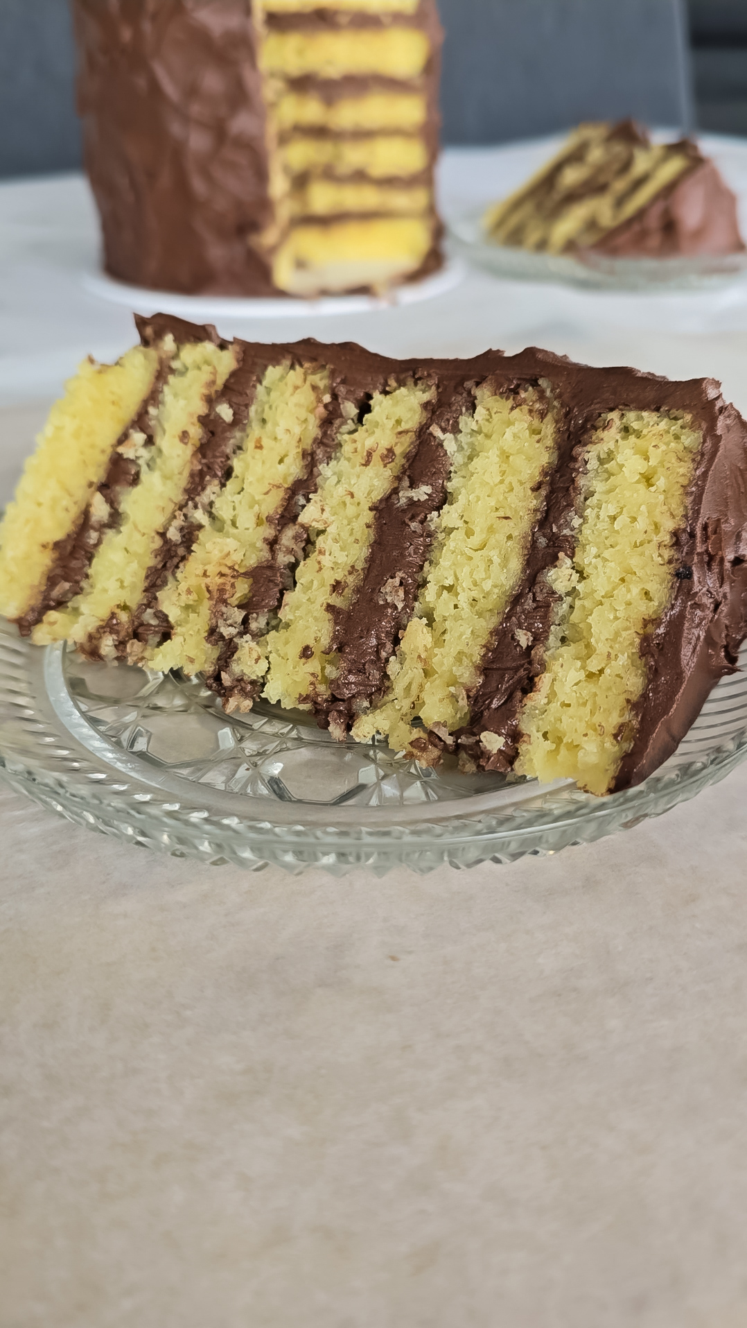 layered yellow vanilla cake with chocolate buttercream frosting