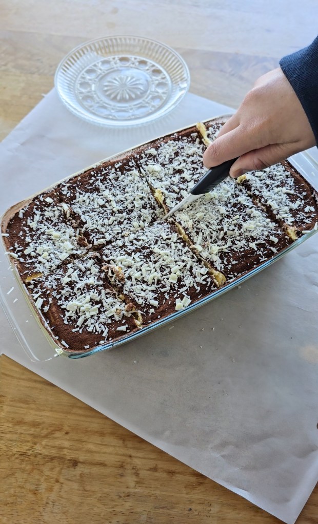 Tiramisu being cut into slices
