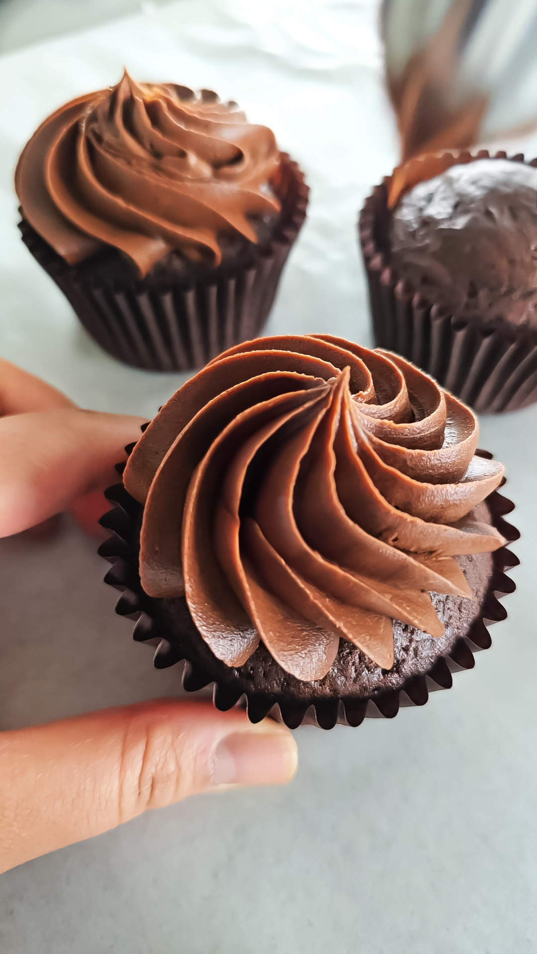 Chocolate cupcake with a chocolate frosting swirl on top