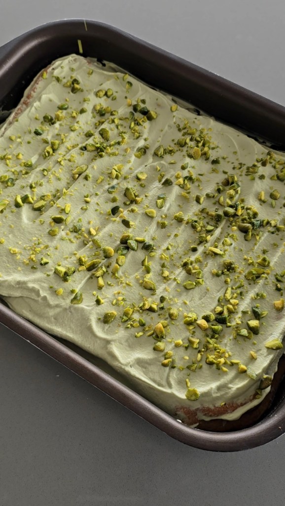 Pan of pistachio cream on a tres leches