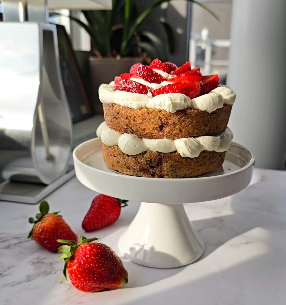 mini 4 inch layer cake with cream frosting and strawberries