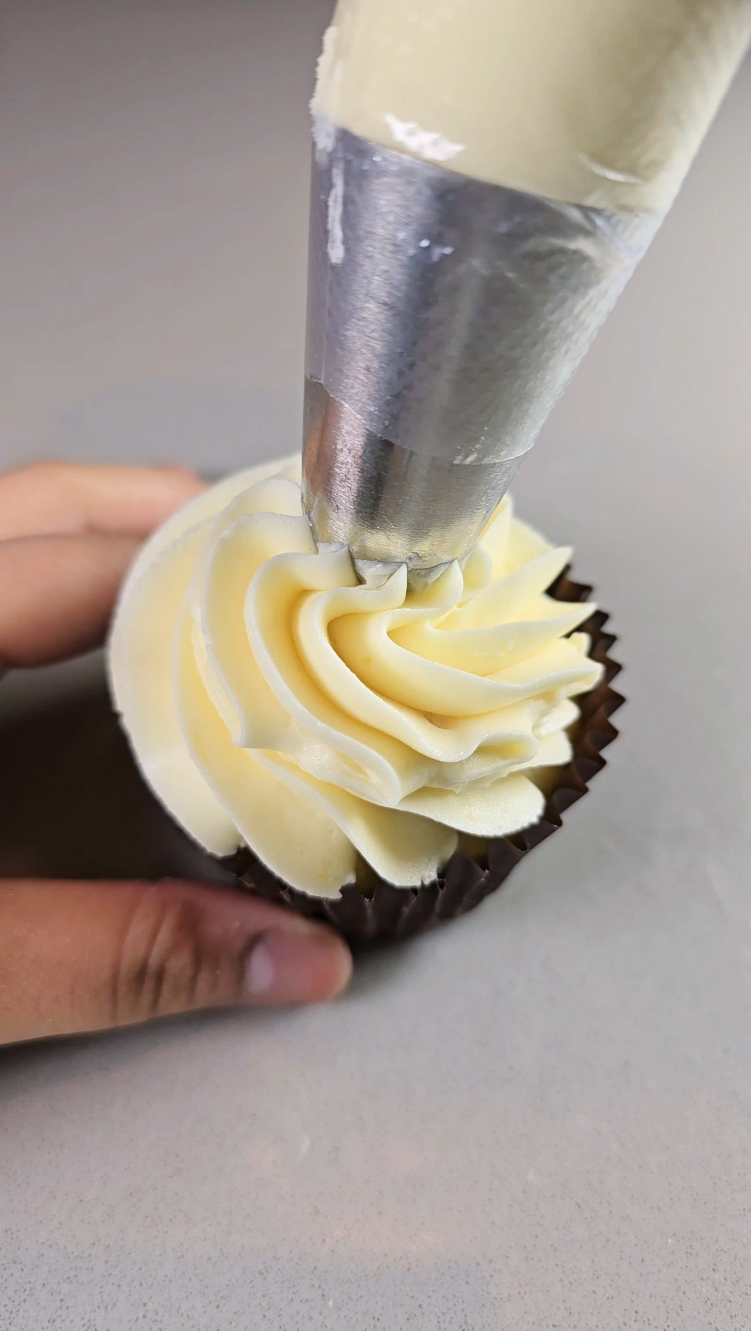 Frosting a cupcake