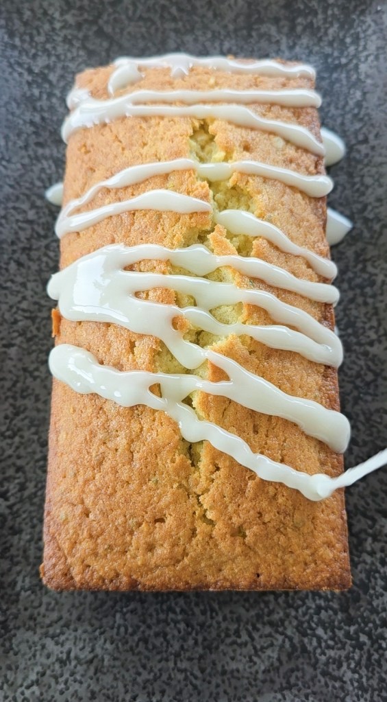 glaze being poured over a tea loaf