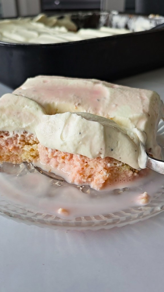 Bite taken from a slice of tres leches rose cardamom