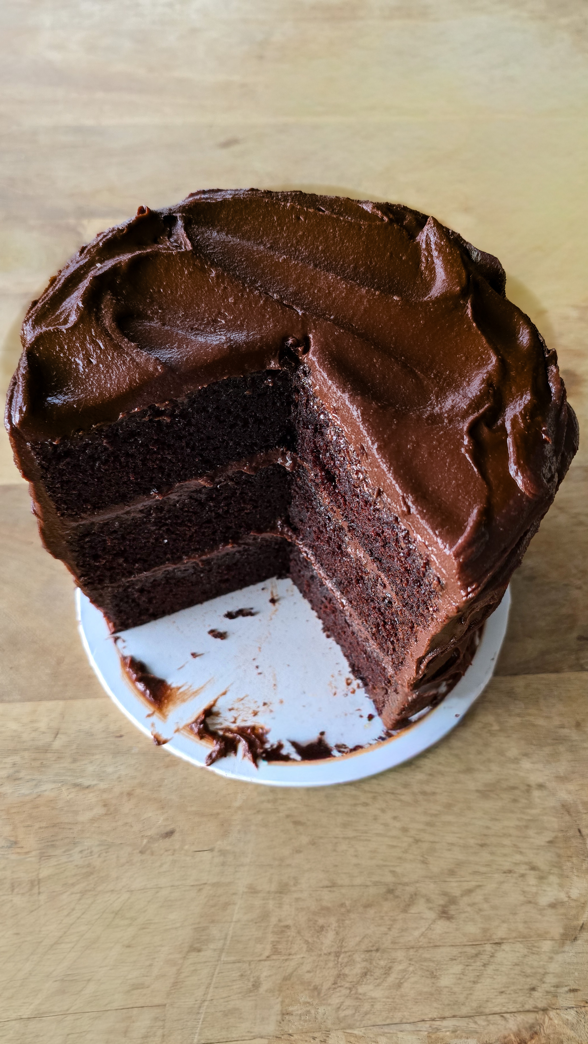 Chocolate layer cake with a slice out of it cross-section