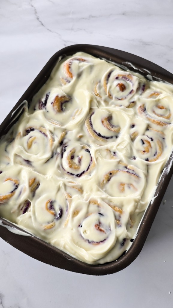 tray of cream cheese frosted cinnamon rolls blueberry cheesecake rolls