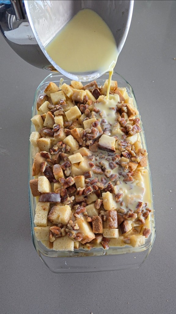 pouring custard over bread pudding